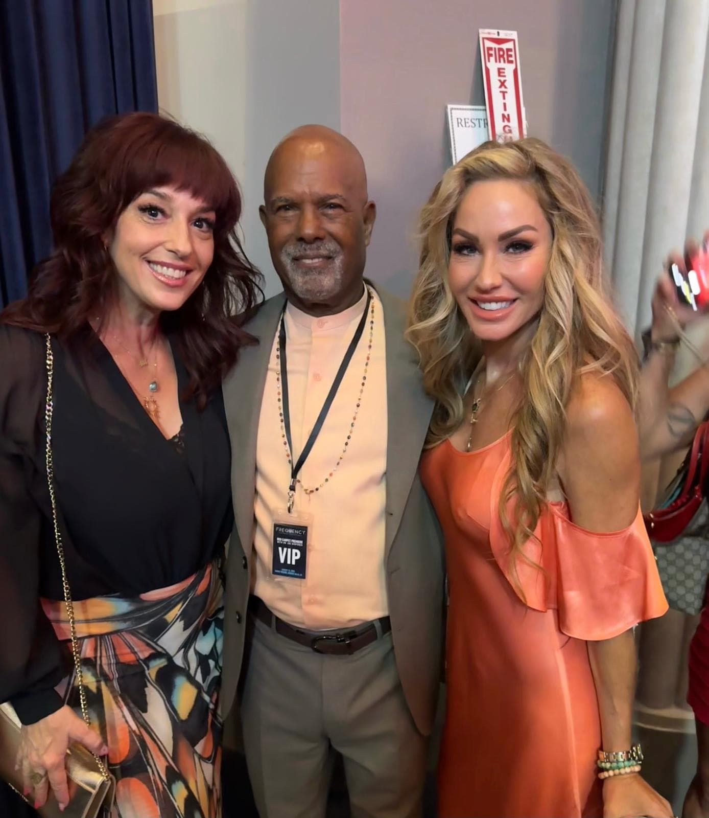 Melanie Marden and Lorna Paul backstage with a guest wearing a VIP badge