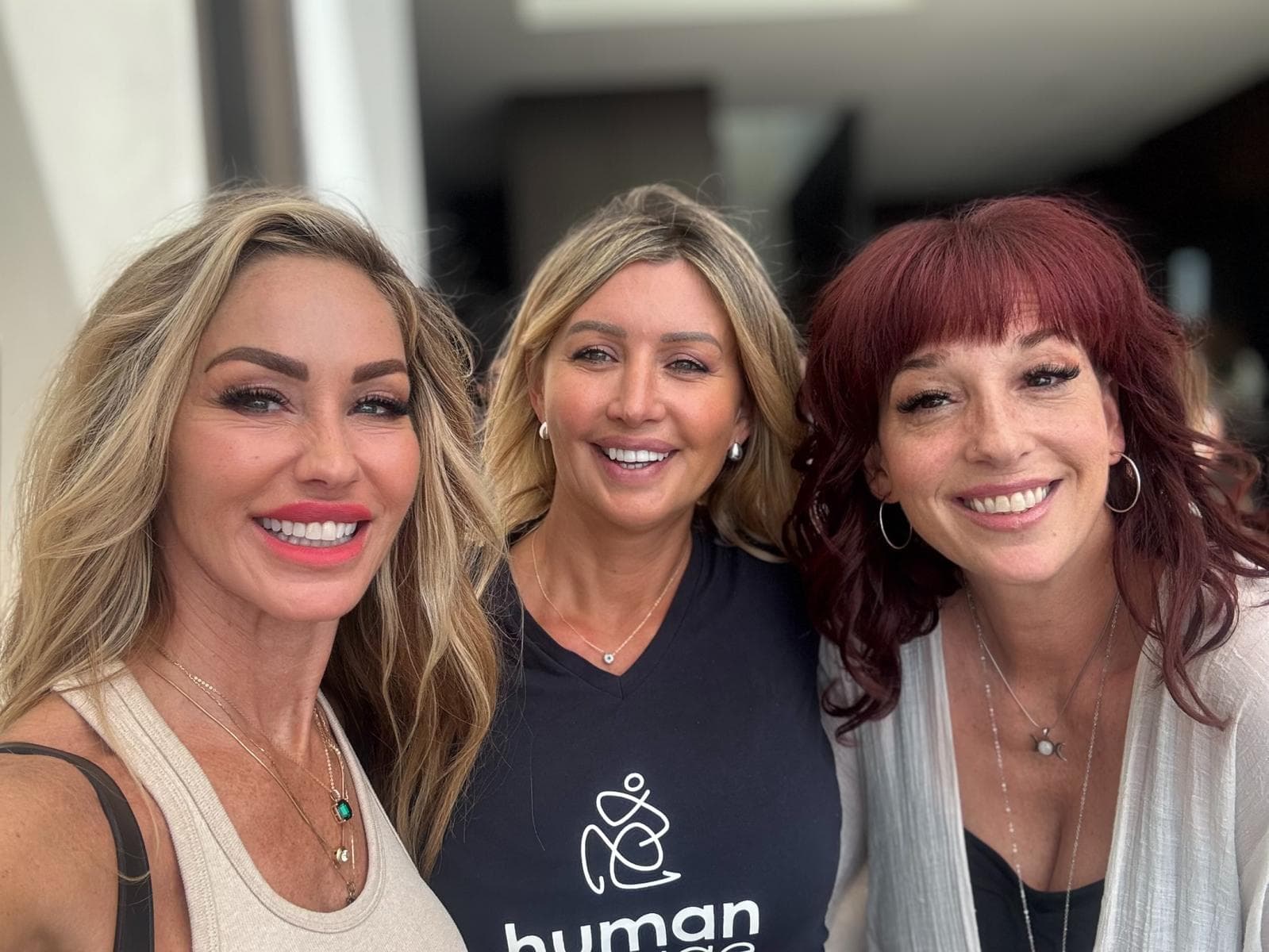 Melanie Marden with two friends, one in a Human Garage shirt