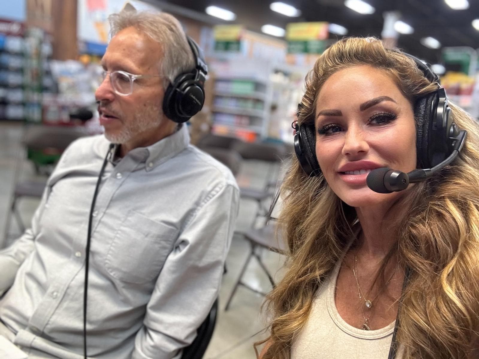 Melanie Marden and a man wearing broadcast headsets during a live segment
